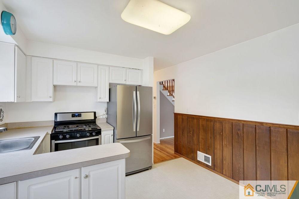 38 Montview Road Edison, NJ 08837 - Photo 15 of 25 a kitchen with a refrigerator and a stove top oven