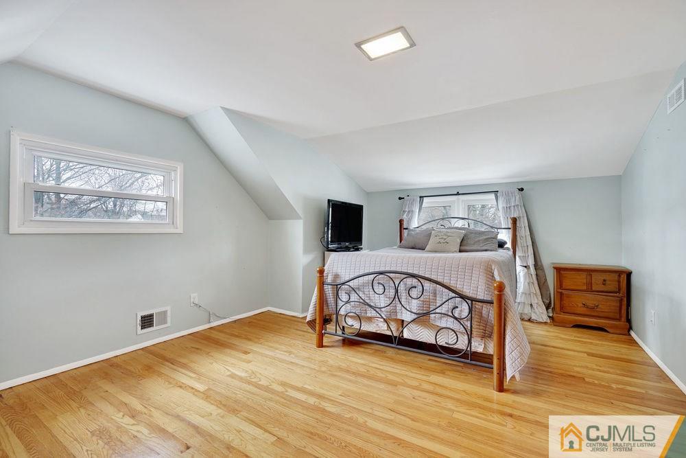 38 Montview Road Edison, NJ 08837 - Photo 17 of 25 a bedroom with a bed and a view of bathroom