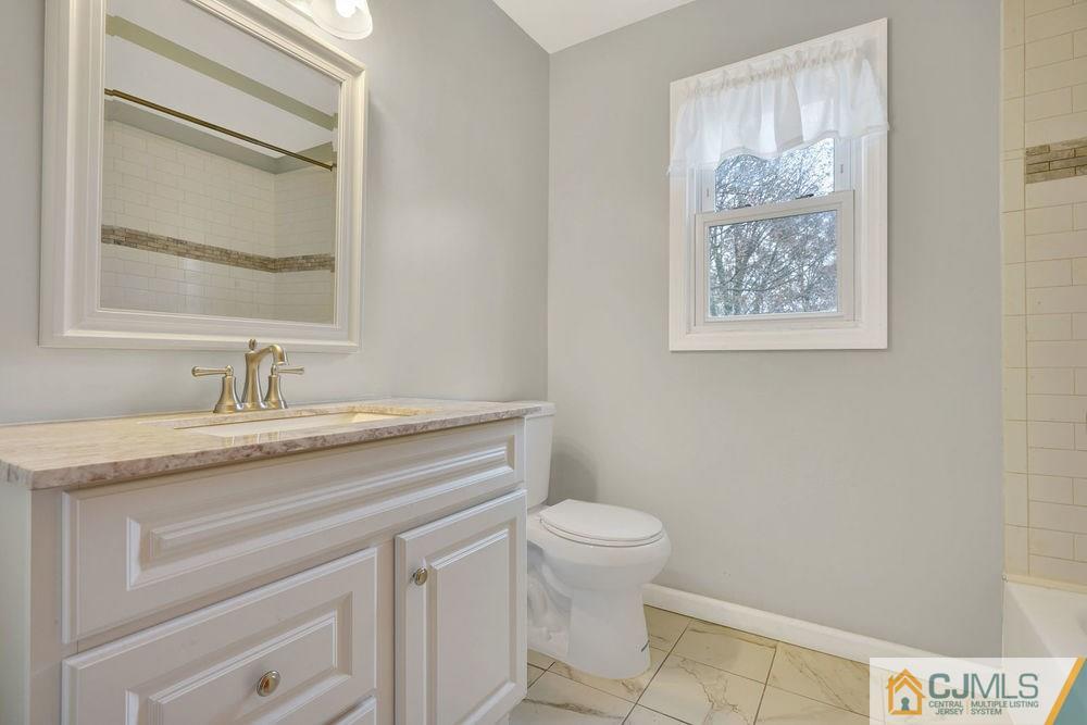 38 Montview Road Edison, NJ 08837 - Photo 20 of 25 a bathroom with a granite countertop toilet sink and mirror