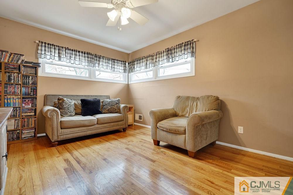 38 Montview Road Edison, NJ 08837 - Photo 8 of 25 a living room with furniture and a chandelier