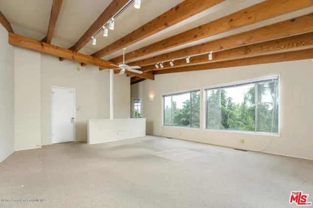 a view of an empty room with windows