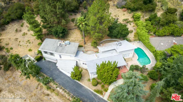 an aerial view of a house with a yard