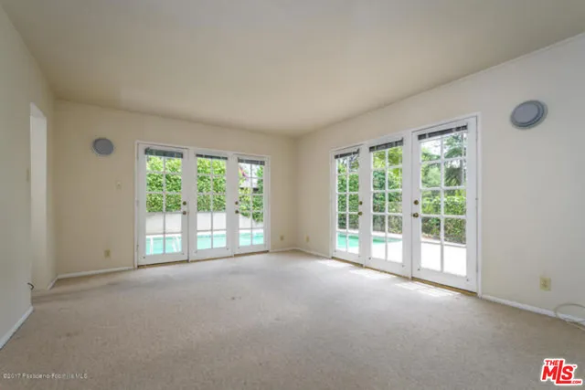 a view of room with a balcony and floor to ceiling window