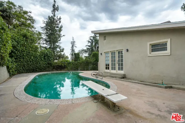 a view of pool with a yard