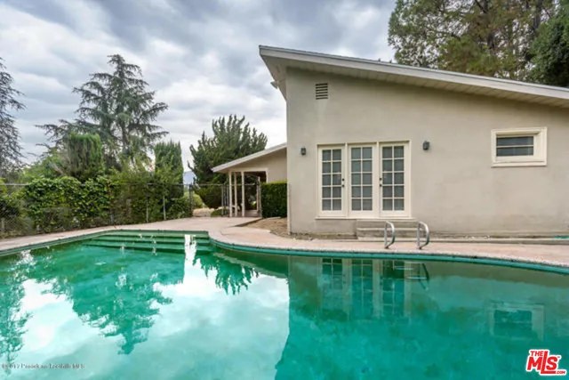 a view of a swimming pool with a yard