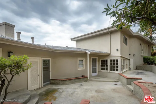 an aerial view of a house with a yard and large trees