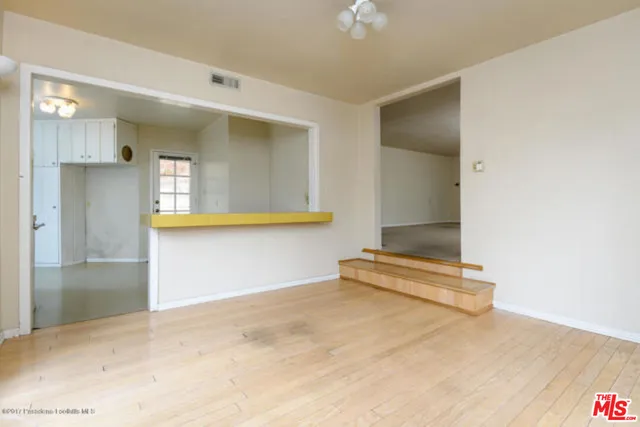 a view of a room with wooden floor and staircase