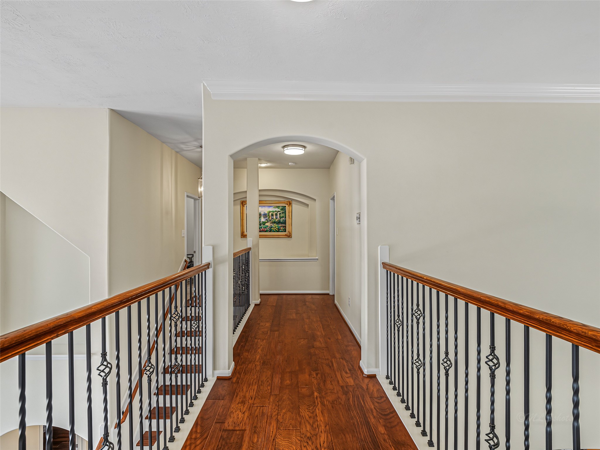 2210 Fox Path Katy, TX 77494 - Photo 39 of 47 A beautiful interior archway softens the transition from the open landing into the private bedroom corridors, enhancing the home's custom architectural character.