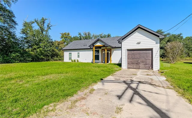 a front view of a house with yard