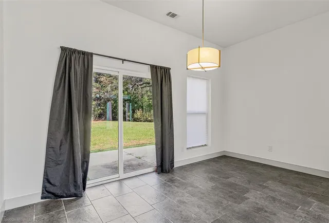 a view of a room with window and ceiling fan