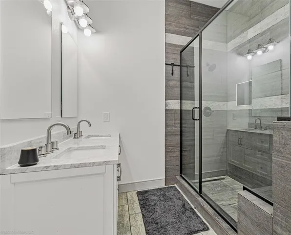a bathroom with a shower sink and mirror