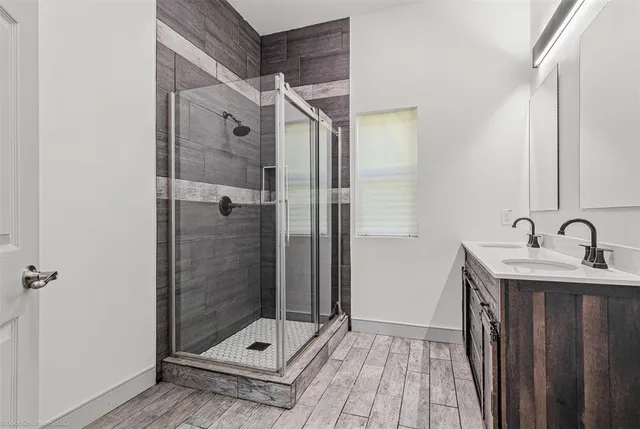 a bathroom with a shower sink and mirror