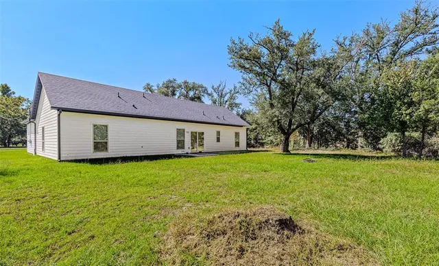 a view of a house with a backyard