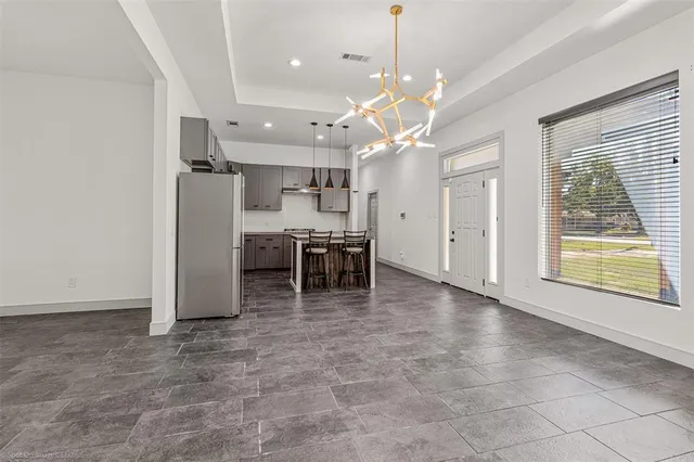 a view of a livingroom with a dinning table and chandelier