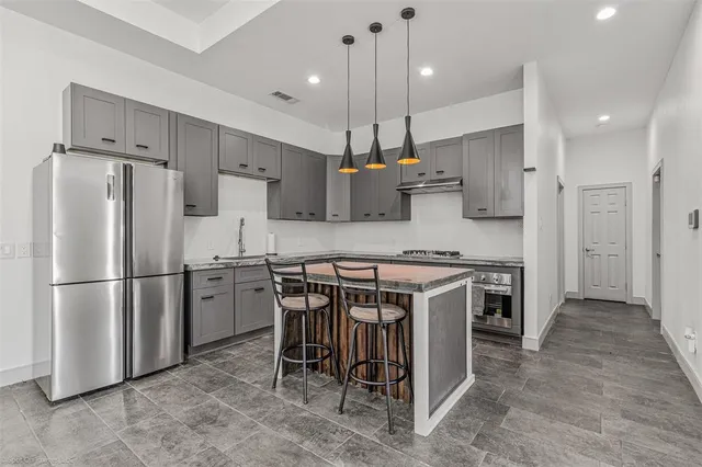 a kitchen with a refrigerator a sink and a stove