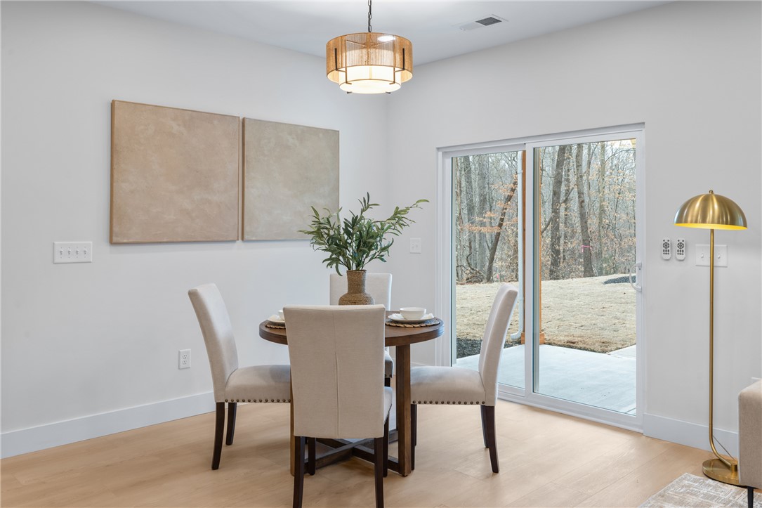502 Point Road Westminster, SC 29693 - Photo 10 of 45 This dining area features light wood flooring and a sliding glass door leading to the outdoors.