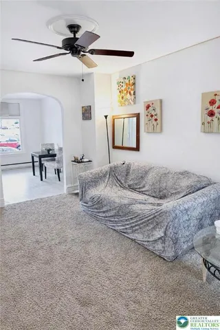 a bedroom with a bed and ceiling fan