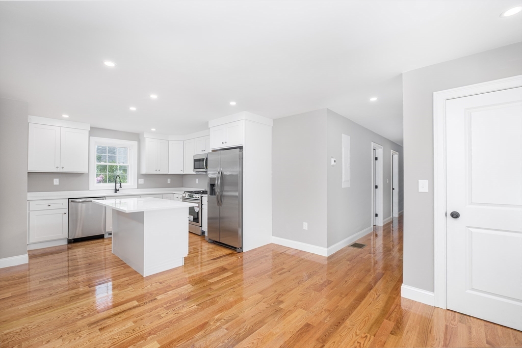 216 Vane Street, Unit 2 Revere, MA 02151 - Photo 3 of 22 a kitchen with white cabinets and stainless steel appliances