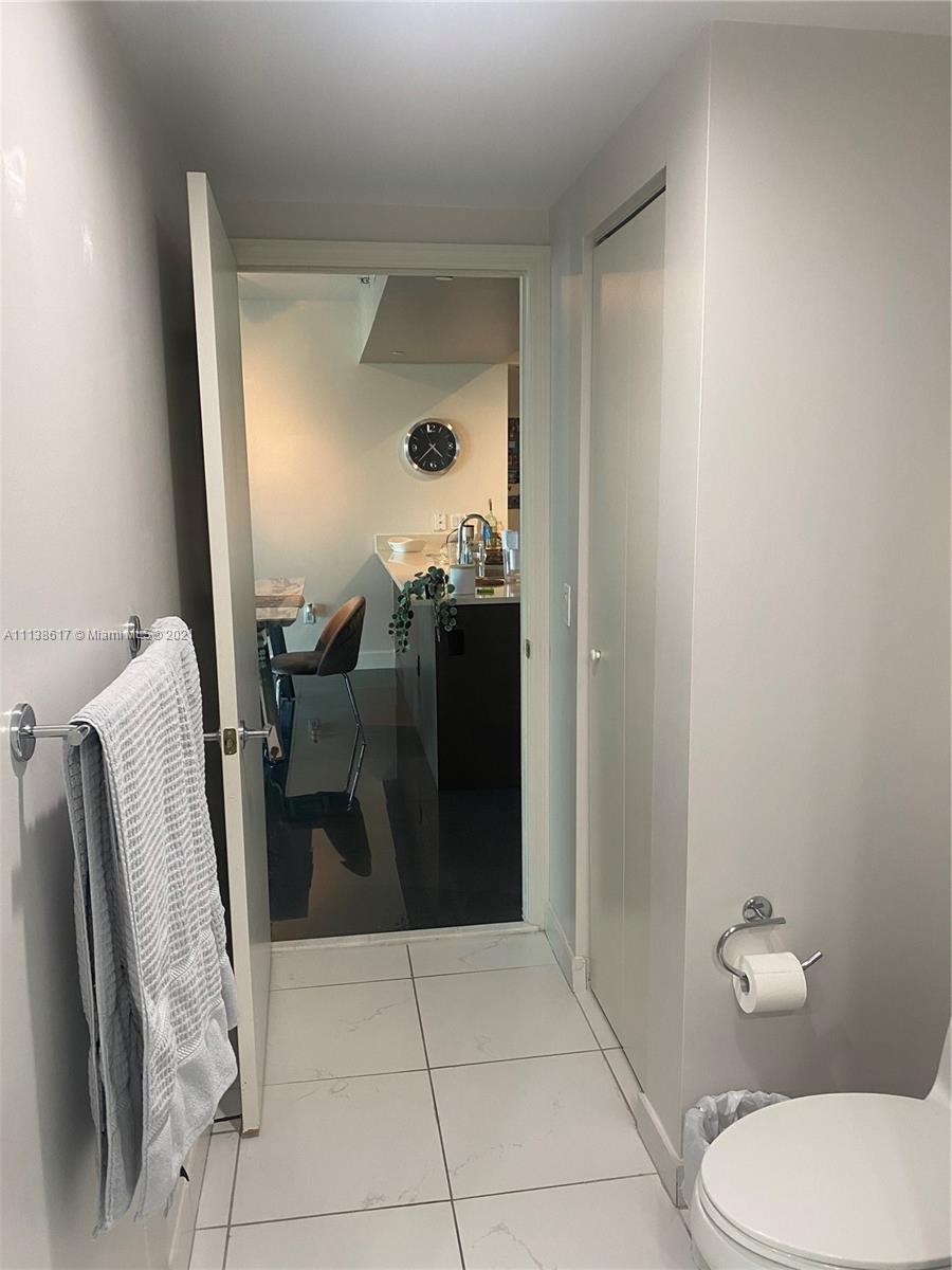 55 Southeast 6th Street, Unit 1903 Miami, FL 33131 - Photo 11 of 23 a bathroom with a sink and mirror