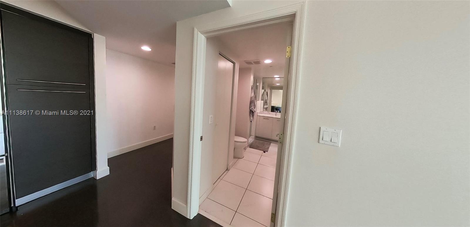 55 Southeast 6th Street, Unit 1903 Miami, FL 33131 - Photo 3 of 23 wooden floor with a bathroom