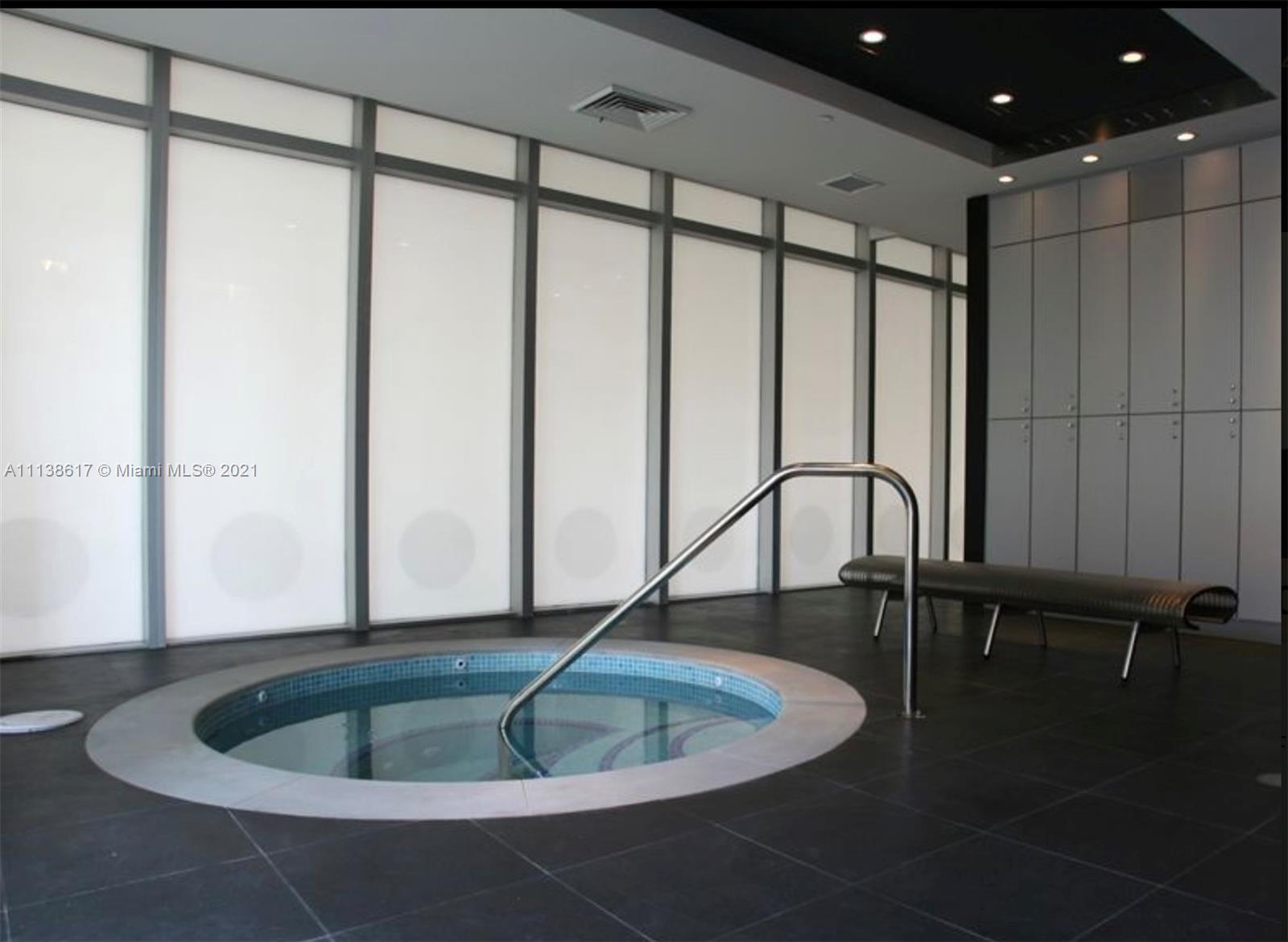 55 Southeast 6th Street, Unit 1903 Miami, FL 33131 - Photo 23 of 23 a view of a living room with a table and chairs