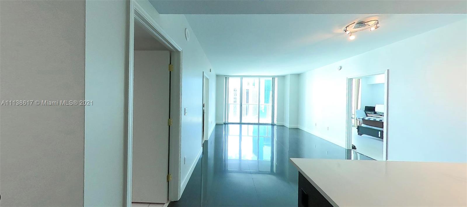 55 Southeast 6th Street, Unit 1903 Miami, FL 33131 - Photo 4 of 23 a kitchen with refrigerator and window