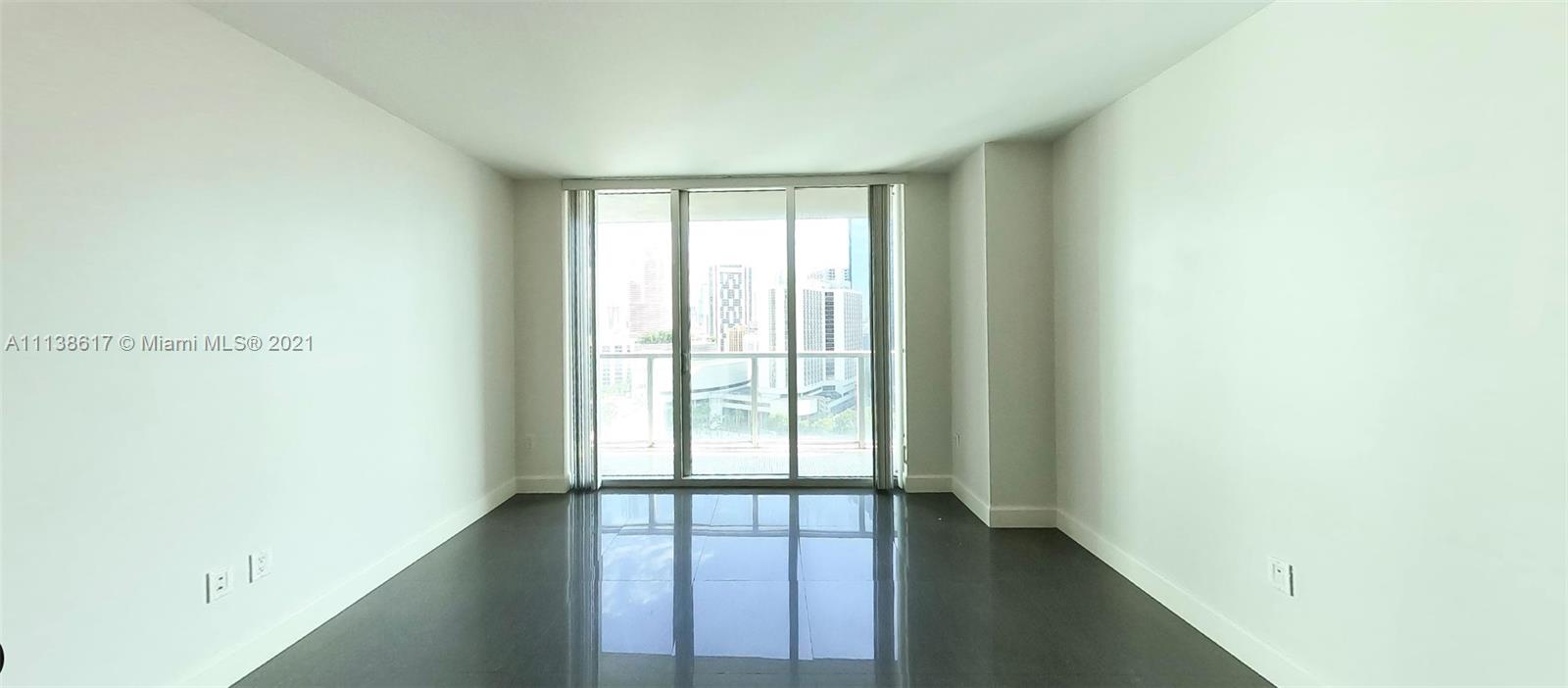 55 Southeast 6th Street, Unit 1903 Miami, FL 33131 - Photo 5 of 23 a view of an empty room with wooden floor