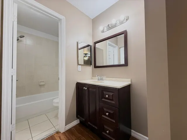 a bathroom with a sink vanity and a mirror