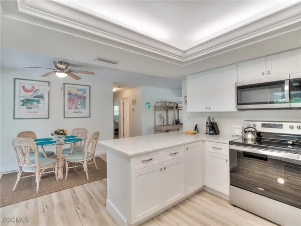 a kitchen with a sink cabinets and wooden floor