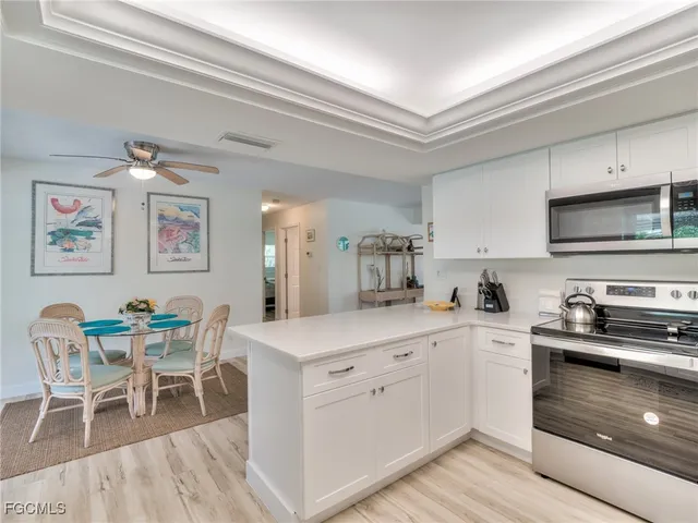 a kitchen with a sink cabinets and wooden floor