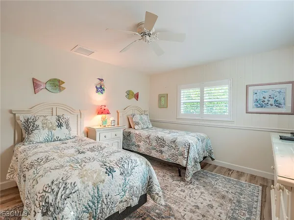 a bedroom with two beds and a window