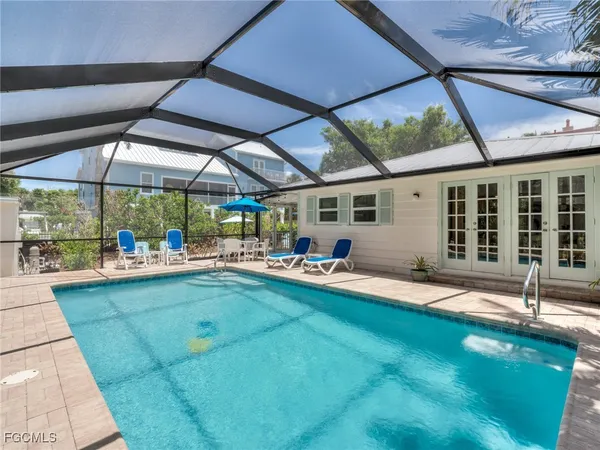 a swimming pool with patio outdoor seating and yard