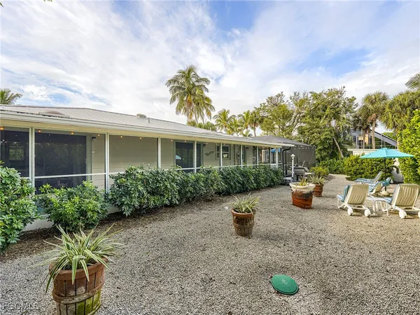 a view of a house with backyard sitting area and garden