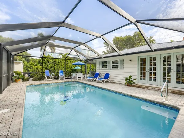 a swimming pool with outdoor seating and yard