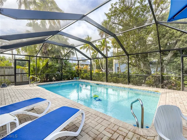 a view of a swimming pool with an outdoor seating
