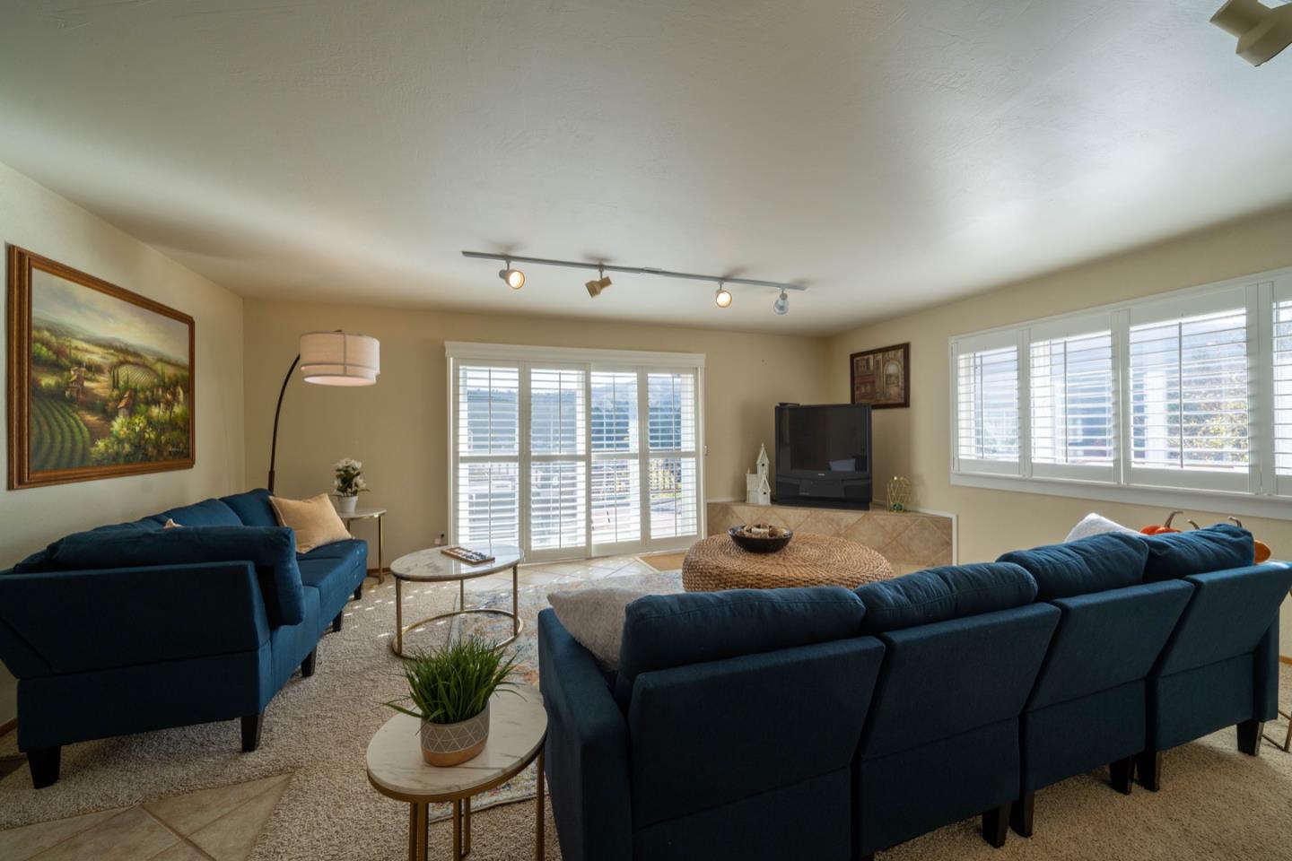 1067 Park Pacifica Avenue Pacifica, CA 94044 - Photo 13 of 25 a living room with furniture a flat screen tv and a large window