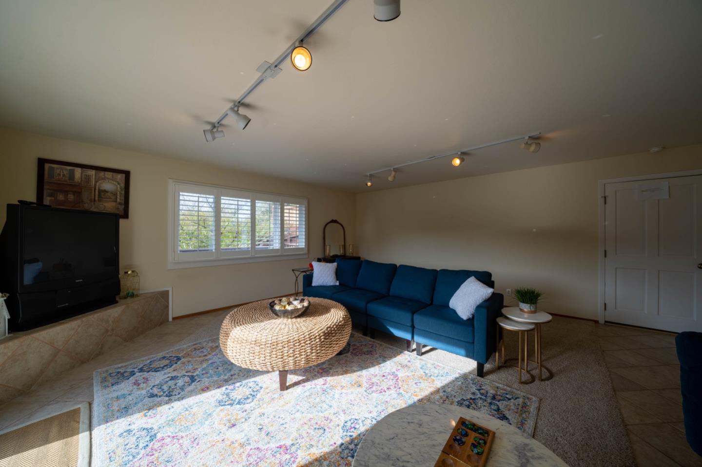 1067 Park Pacifica Avenue Pacifica, CA 94044 - Photo 15 of 25 a living room with furniture and a flat screen tv