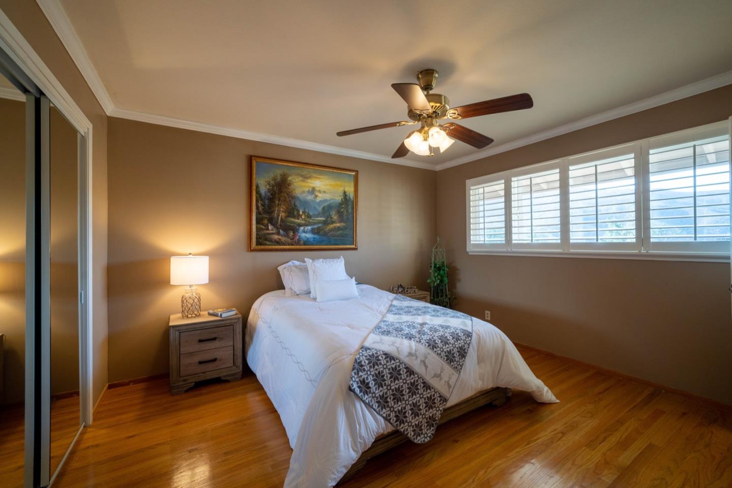 1067 Park Pacifica Avenue Pacifica, CA 94044 - Photo 16 of 25 a bedroom with a bed and a chandelier