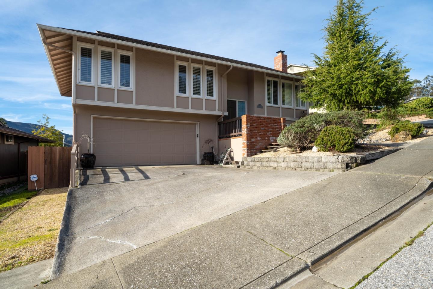 1067 Park Pacifica Avenue Pacifica, CA 94044 - Photo 2 of 25 a front view of a house with a yard