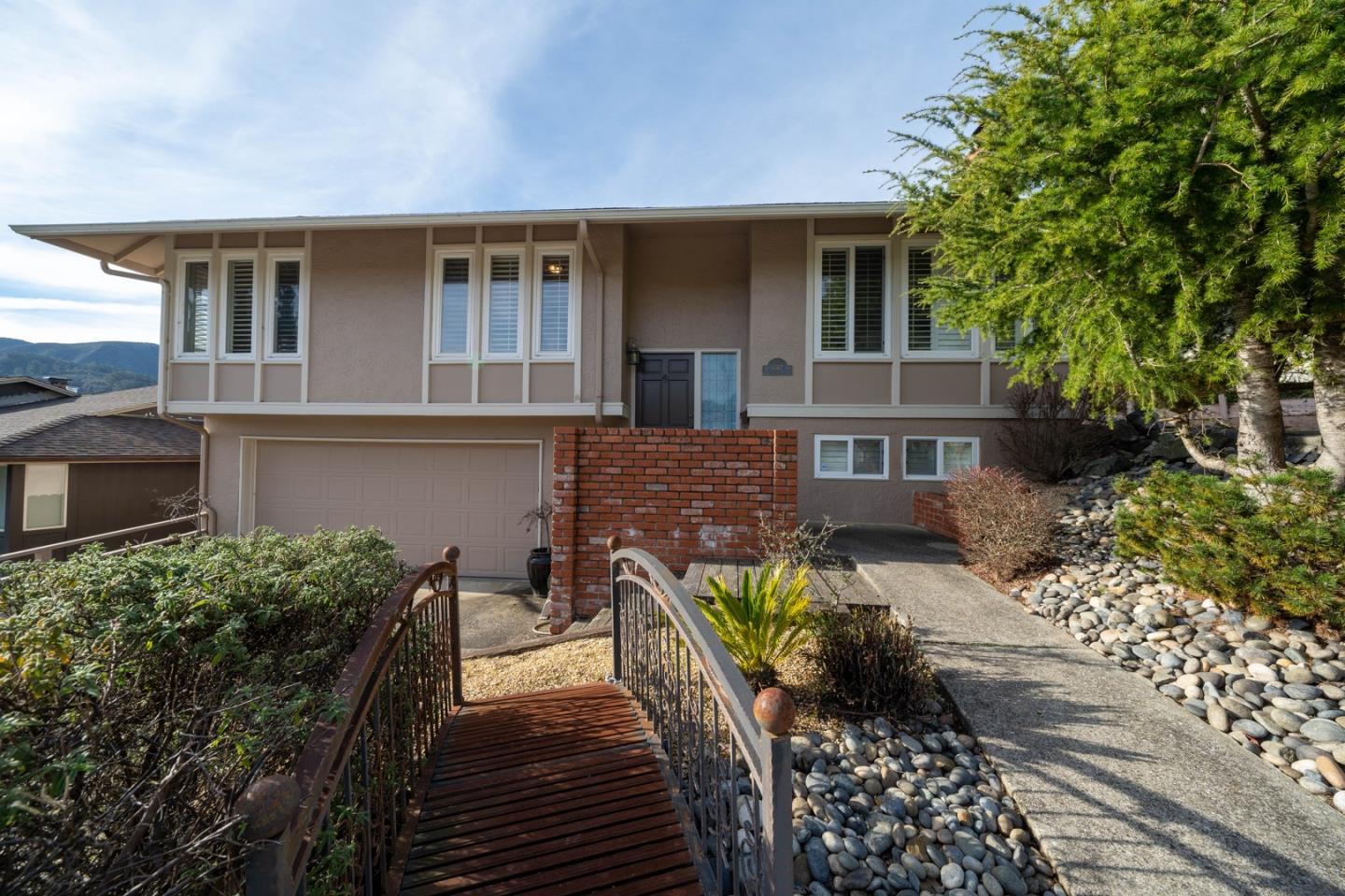 1067 Park Pacifica Avenue Pacifica, CA 94044 - Photo 4 of 25 a front view of a house with a yard
