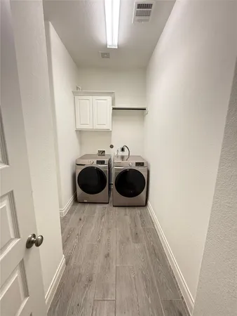 a view of a kitchen with a sink and wooden floor