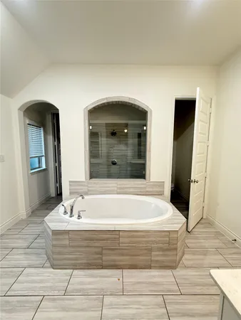 a bathroom with a bathtub and a sink
