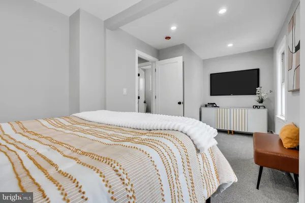 a bedroom with bed and tv