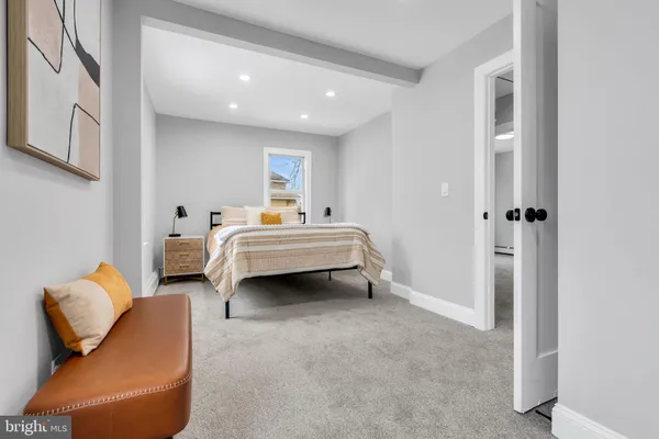 a spacious bedroom with a bed and a couch