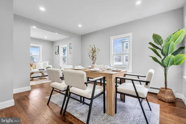 a living room with furniture a desk and chair with wooden floor