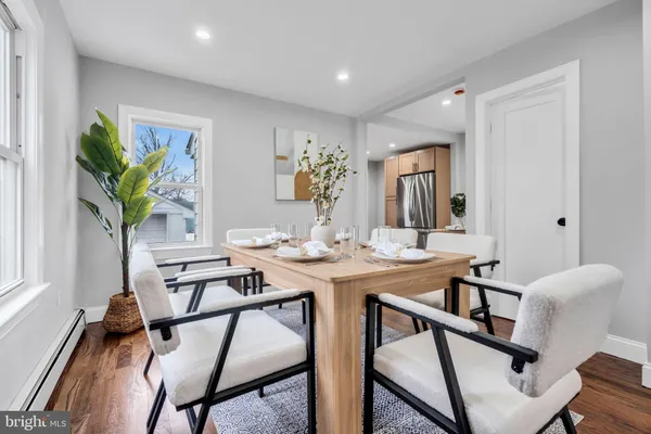a view of a dining room with furniture and a potted plant