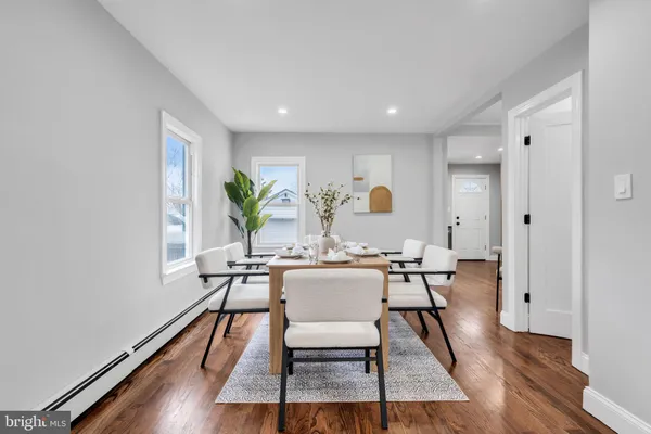 a view of a dining room with furniture and wooden floor