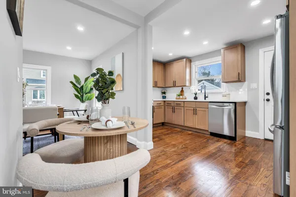 a living room with kitchen island furniture and a chandelier