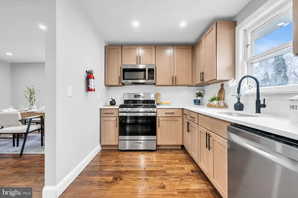 a kitchen with stainless steel appliances granite countertop a stove and a sink