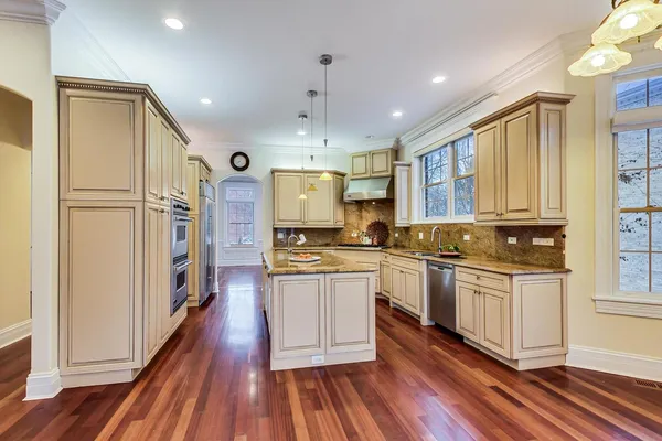 a kitchen with granite countertop a sink stove and refrigerator